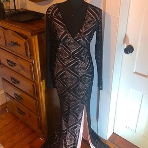 Black long sleeve lace gown with side slit and nude lining.